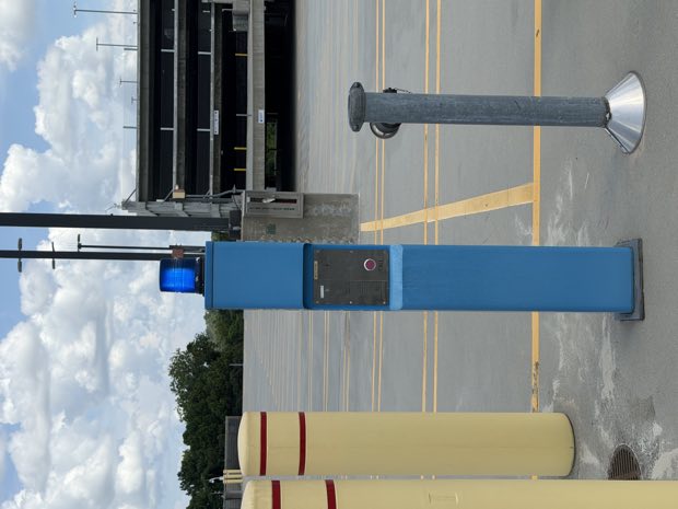 Bollard-mounted credential reader in a parking lot