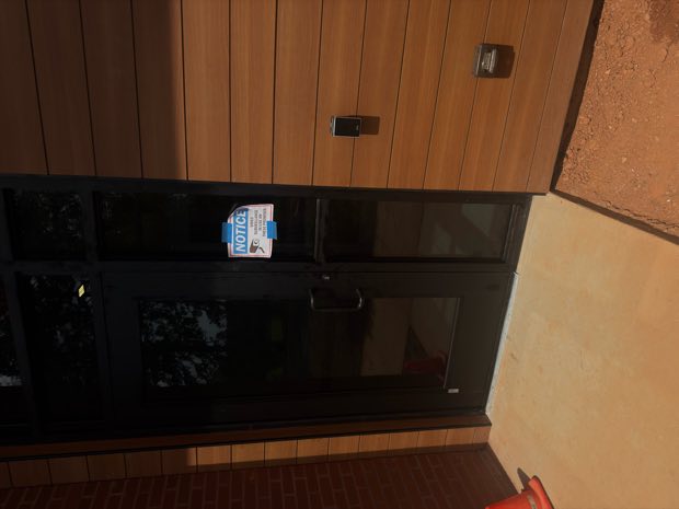Entry reader and intercom at a glass and timber entrance