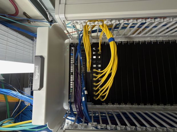 Yellow fiber jumpers running into a rack-mounted switch