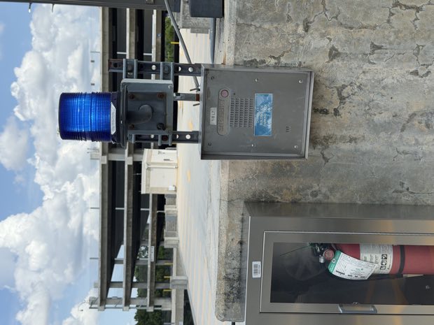 Gate controller enclosure mounted at a vehicle entrance