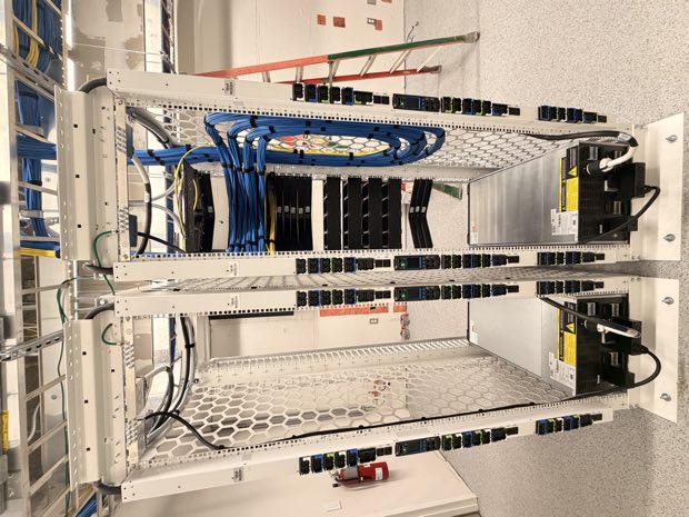 Open-frame rack with patch panels and vertical managers