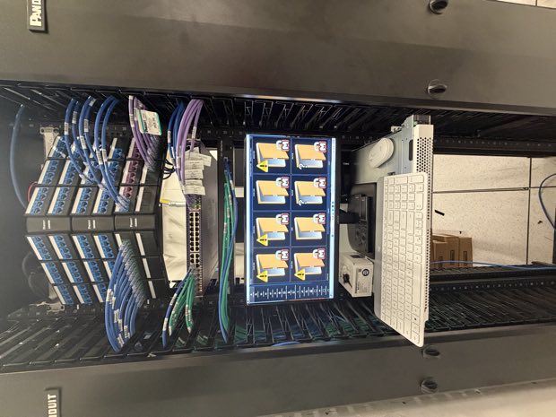 Equipment rack beside a video monitoring display