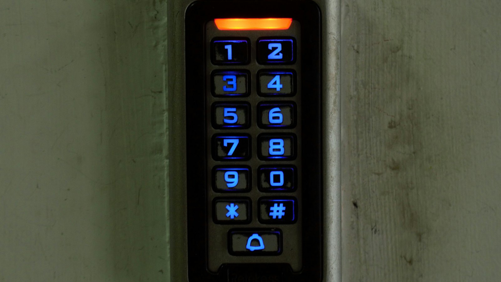 Illuminated keypad entry panel at a building entrance